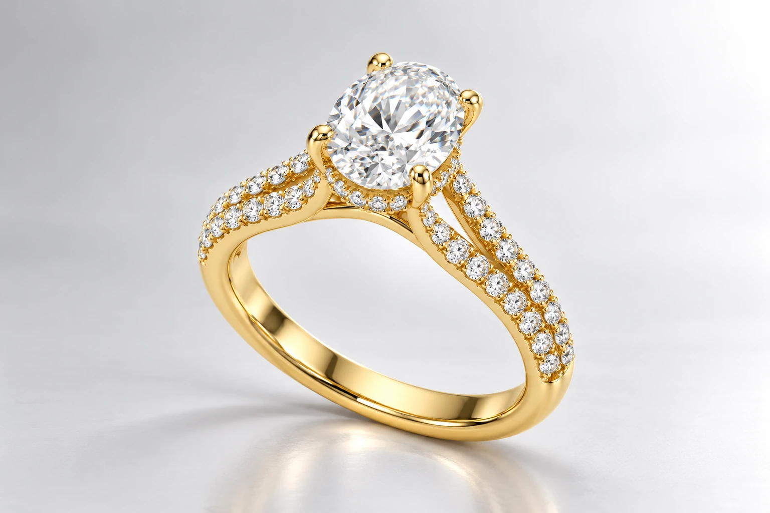 Studio design visualisation of a yellow-gold oval hidden halo ring on a pearl-grey backdrop, Victoria Diamonds