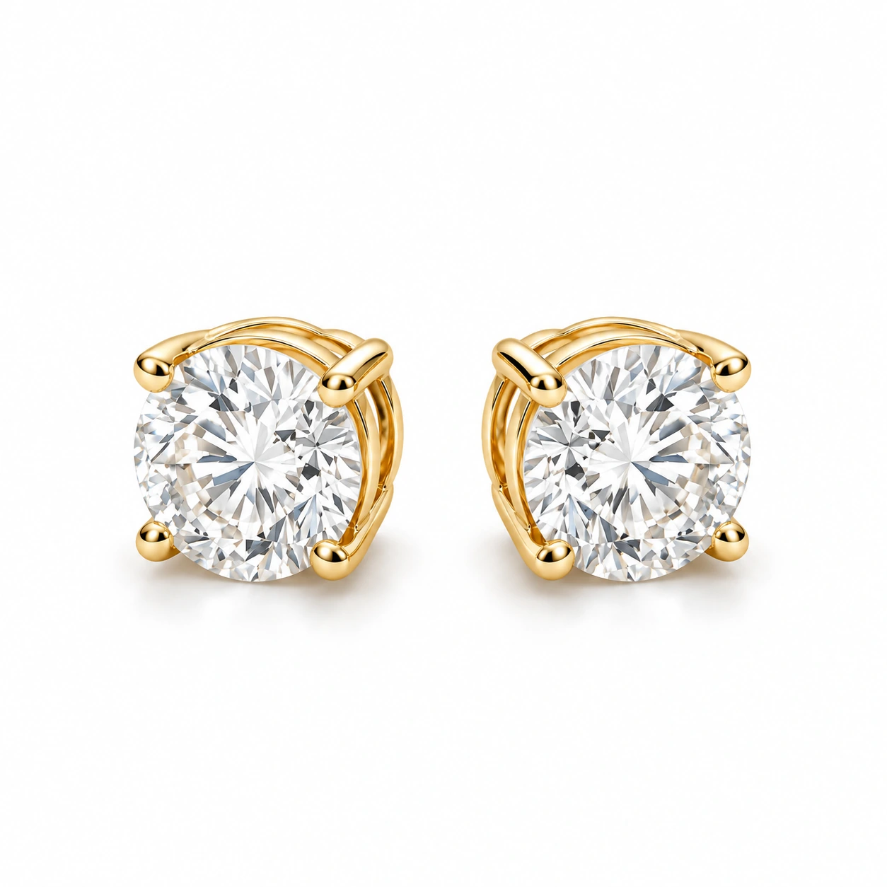 Pair of diamond stud earrings shown together on a white background